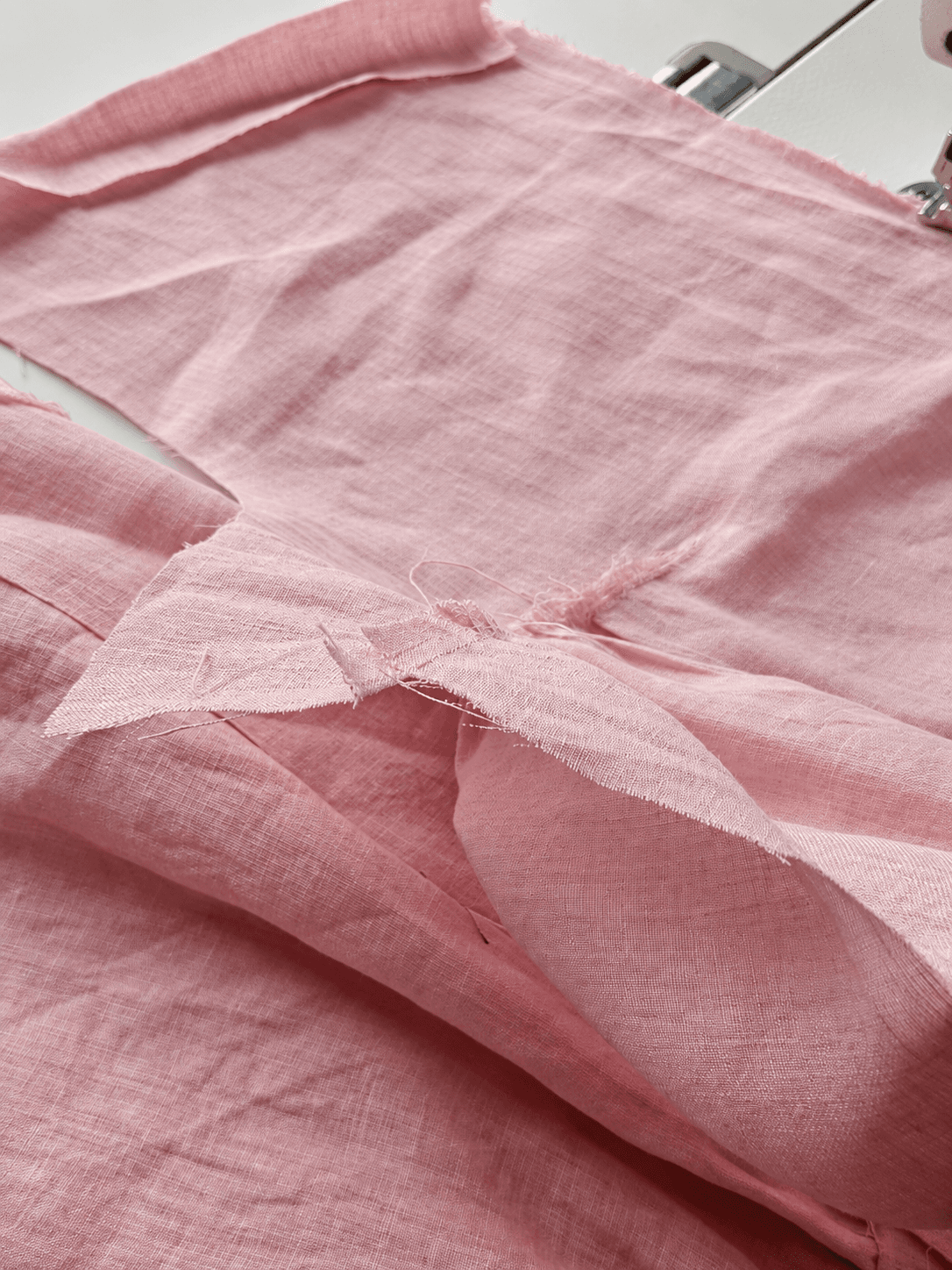 Dusty-rose linen garment pieces in the Label AshB workshop